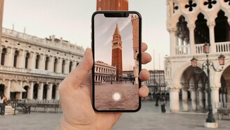 Uno smartphone inquadra la torre dell'orologio a Piazza San Marco, uno dei luoghi-simbolo della ultura italiana, Venezia
