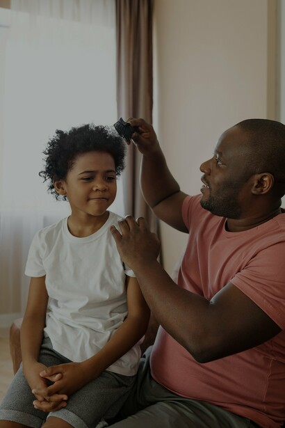 A father doing his son's hair 