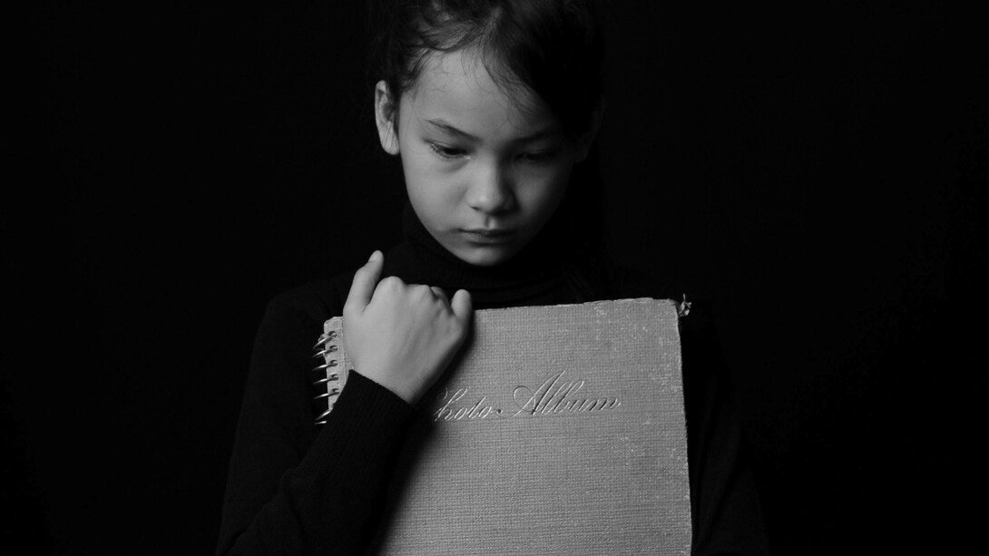 Girl lowers her gaze in sadness
