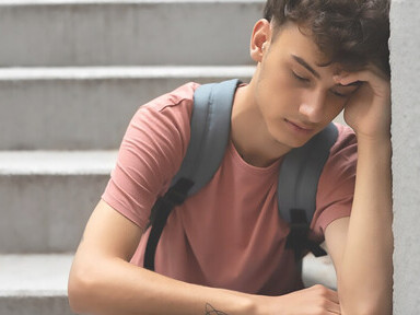 Delve into the emotional portrayal of a despondent boy sitting on stairs, offering a front-view perspective on sadness and introspection