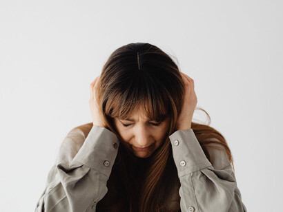 Overwhelmed and exhausted, the woman grapples with the weight of unrelenting demands in both her personal and professional life