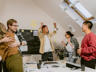 Happy team in a meeting room, brainstorming ideas and demonstrating diverse collaboration and workplace creativity