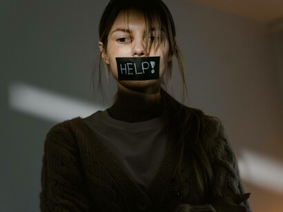Woman silenced with a help sign