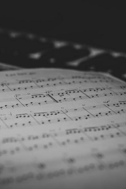 A sheet of music that is laying on a table