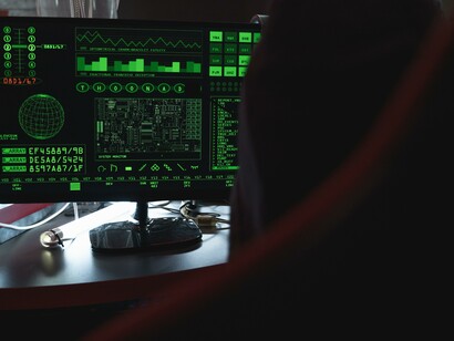 Computer code on a screen in a dark room