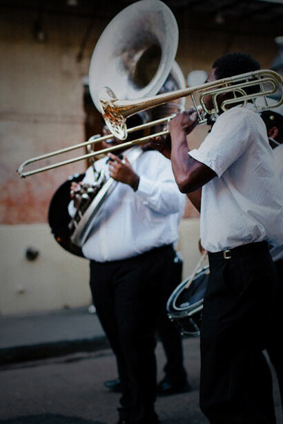 A crowd watching musicians play at a lively street festival in New Orleans, USA