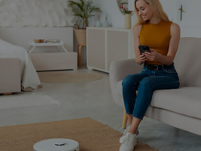 Discover the efficiency of a robot vacuum cleaner as a person seamlessly navigates their home, showcasing the convenience and effectiveness of automated cleaning