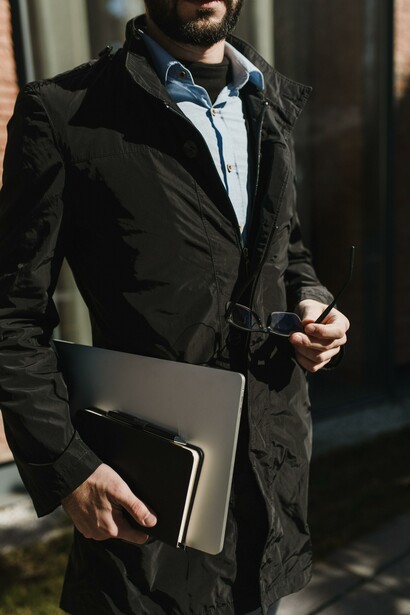 Businessman holding a laptop and notebook