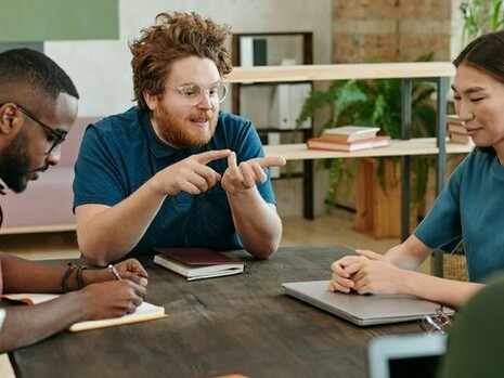 A group of young adults in discussion, reflecting how youth collaborate to address global issues