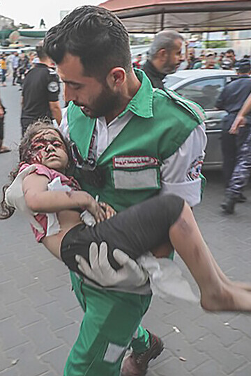 Emergency medics swiftly transport injured Palestinian child to Al-Shifa Hospital in Gaza City after Israeli airstrike on October 11, 2023