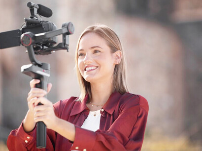 A woman recording herself for media, showcasing women in media and their role in breaking stereotypes in films