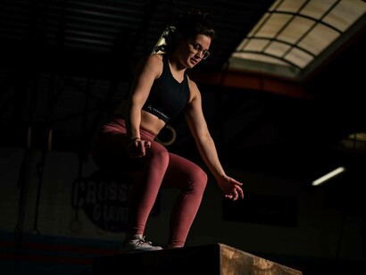 A woman gets ready for a vertical jump