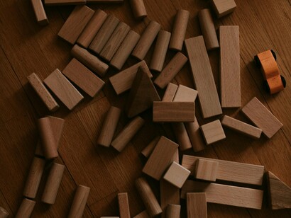 Disordered blocks spread across an open surface, reflecting the unravelling of systems that once defined stability