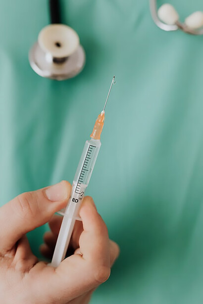 In a symbol of hope and medical expertise, a doctor's hand confidently holds a vial of vaccine, underscoring the significance of vaccinations in healthcare