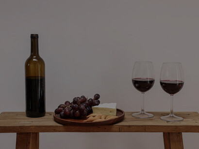 A selection of cheeses and glasses of wine arranged on a stylish table