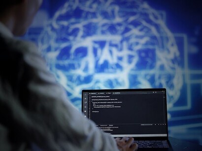 An IT specialist in a modern apartment office utilizes programming expertise to optimize artificial intelligence systems