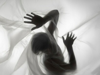 Eerie hand silhouettes and looming shadows, portraying the anguish of anxiety and a person in distress
