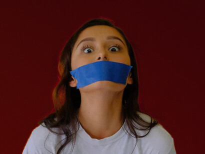 A woman silenced with tape on her mouth. To some extent, we are trying to please our audience. We want a positive review or comment on anything we write or say