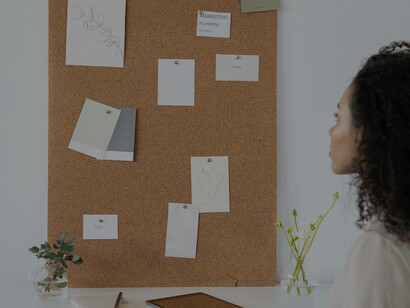A woman staring at her idea validation board in the hope of making it airtight