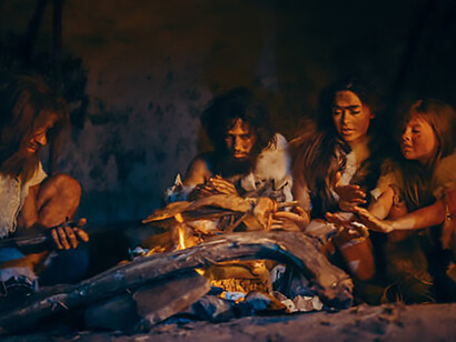Prehistoric hunter-gatherer tribes, including Neanderthals and Homo sapiens, are depicted cooking and enjoying animal meat around a bonfire in a cave setting, showcasing the early origins of communal cooking and dining rituals