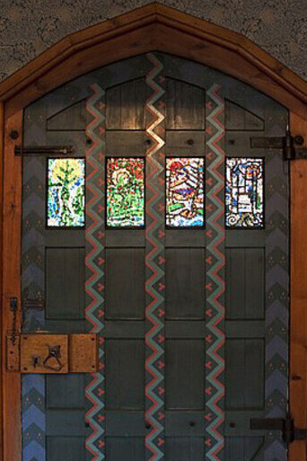The door of the Red House is a striking example of the Arts and Crafts ethos, featuring intricate craftsmanship and a medieval-inspired design, London, England