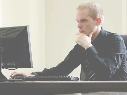 A Millennial in his minimalist office attempting to sort out the next move for the company and if he is the right fit