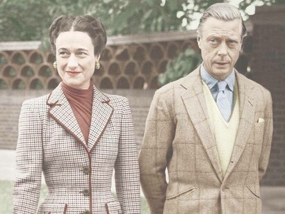 A couple wearing tweed outdoors in a garden