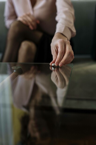 Woman places wedding band on table