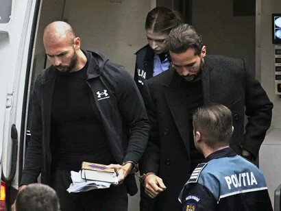 Police escorting Andrew and Tristan Tate into the precinct in Romania