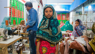 In a factory far from the consumer's eye, a girl works tirelessly for wages that barely cover the cost of living, embodying the human cost of fast fashion