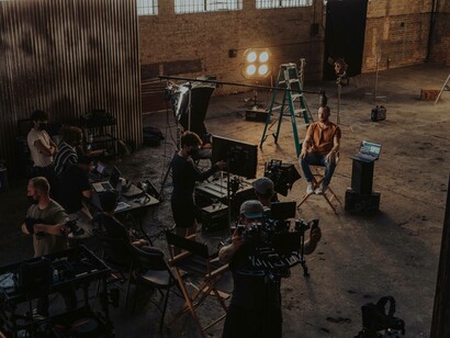 An all-male film crew is ready to film a male actor in an indoor location lending credence to the claim that there are fewer opportunities for women 