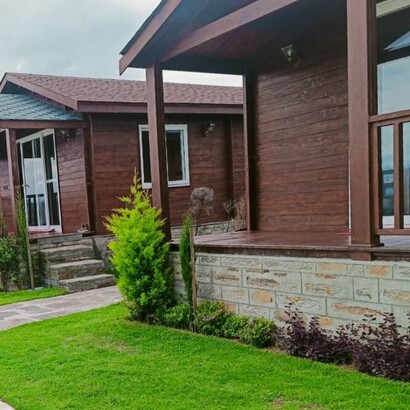 Wooden cottages built by Woods Villa in Dhamas Village, India