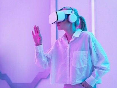 A woman wearing a virtual reality headset, exploring the impact of bias in AI systems
