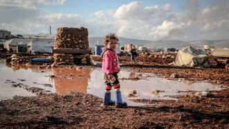 A child, who lives in poverty, stood alone by a puddle. Re-editing failed revolutions and ideologies is an understandable practice because of the permanence of oppression and inequality