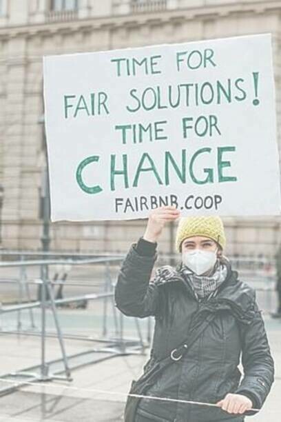 Woman holding sign reminding people to take care of the planet, global protest, 19 March 2021
