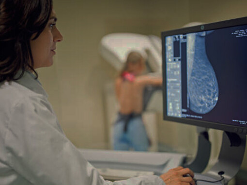 A doctor operates a mammography X-ray scanner in a hospital, utilizing artificial intelligence (AI) technology to enhance breast cancer screening and diagnosis