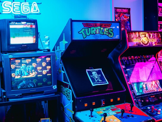 An old-school arcade with iconic Sega machines, representing the resurgence of retro gaming as a modern passion