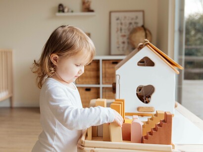A toddler ready to play creatively in a relaxed and concentrated manner