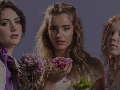 Women posing gracefully with bouquets of flowers, epitomizing beauty and elegance in a natural setting