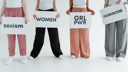 Women holding empowerment signs