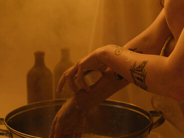 A woman carefully washes her hands in a clean bathroom setting