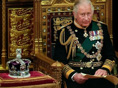 Prince Charles is seated and waiting next to the Queen's crown at the Palace of Westminster in London, May 10, 2022
