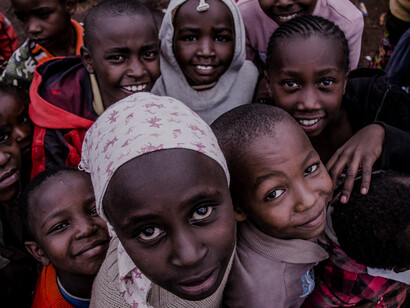 Their smiles reveal a sense of community and hope, underscoring the importance of investing in education and social programs to uplift children in impoverished areas