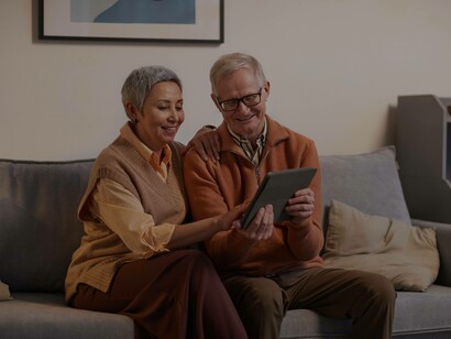 A couple examining their worth in the silver economy via a tablet