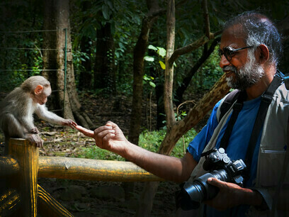 Author and monkey baby reaching out to each other, Athirapally Falls (Kerala) @ Sujatha Padmanabhan