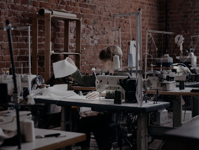 With a smile on her face, this worker demonstrates the joy of creating high-quality clothing in an environment that values fair labour practices