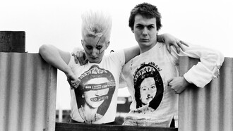 Pamela Rooke, known as Jordan, and Simon Barker, called Six, model Westwood's 'God Save The Queen' tees