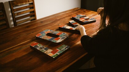 Tiles that spell out 'love' on a table