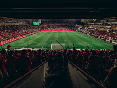 Fans enjoy an exciting soccer match at Abu Dhabi Stadium, United Arab Emirates
