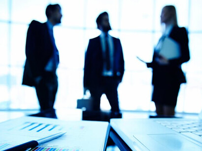 The technology industry's economic growth and market dynamics with a close-up of a financial report, set against a backdrop of businesspeople, highlighting the impacts of government intervention and competition